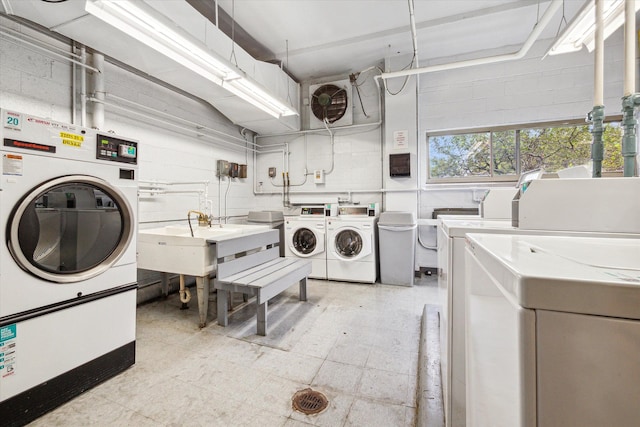 washroom featuring washer and clothes dryer and sink