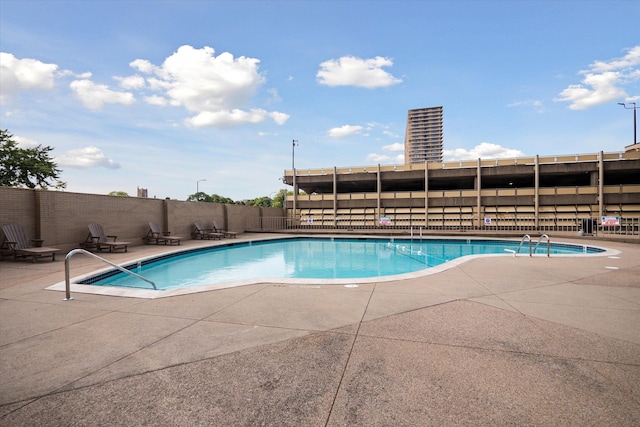 view of swimming pool featuring a patio area