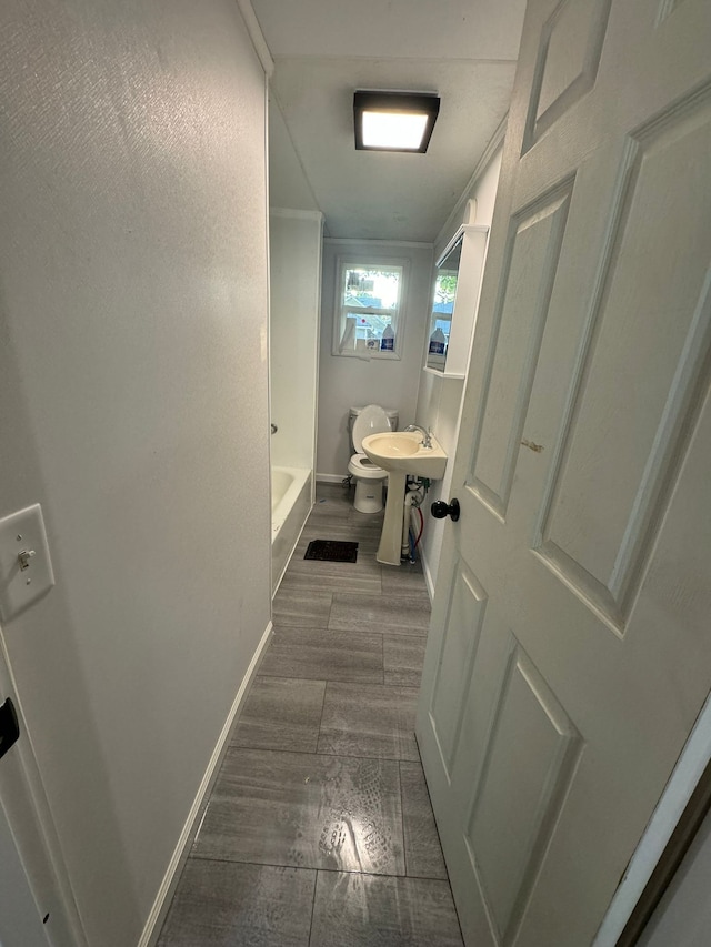 bathroom with wood-type flooring, toilet, and sink