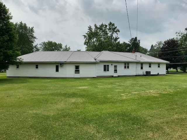 back of property with a lawn