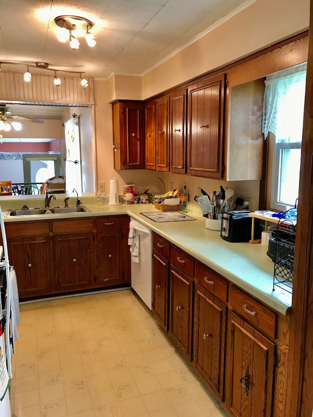 kitchen with ceiling fan, sink, white dishwasher, a textured ceiling, and track lighting