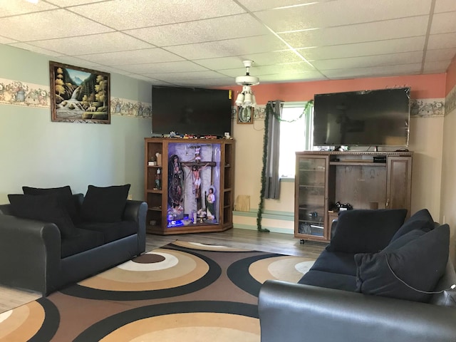 living room with wood-type flooring and a paneled ceiling