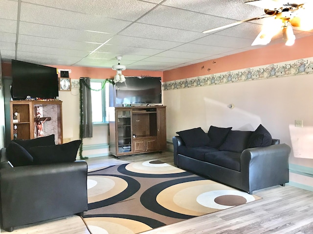 living room featuring a paneled ceiling, light hardwood / wood-style flooring, and ceiling fan