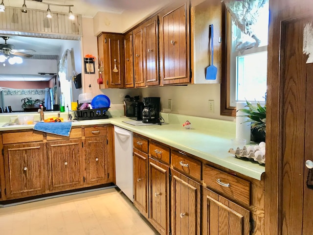 kitchen featuring white dishwasher, ceiling fan, and sink