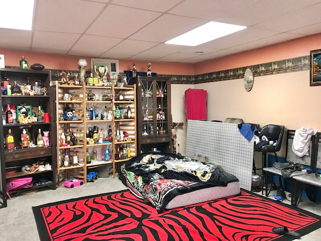 bedroom featuring carpet flooring and a paneled ceiling