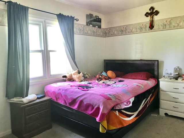 carpeted bedroom with multiple windows