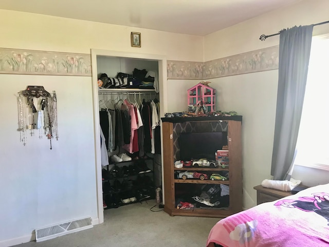 carpeted bedroom with a closet