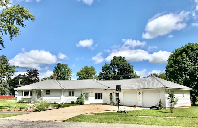 single story home featuring a garage and a front yard