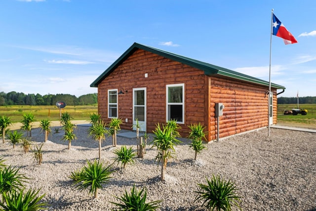 view of side of home featuring a rural view