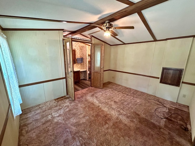 spare room featuring vaulted ceiling with beams, ceiling fan, and carpet floors