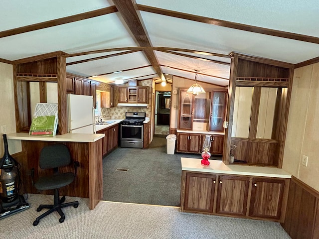 kitchen featuring hanging light fixtures, stainless steel stove, vaulted ceiling with beams, white fridge, and kitchen peninsula