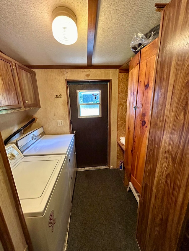 laundry room featuring washer and dryer, cabinets, carpet floors, and a textured ceiling