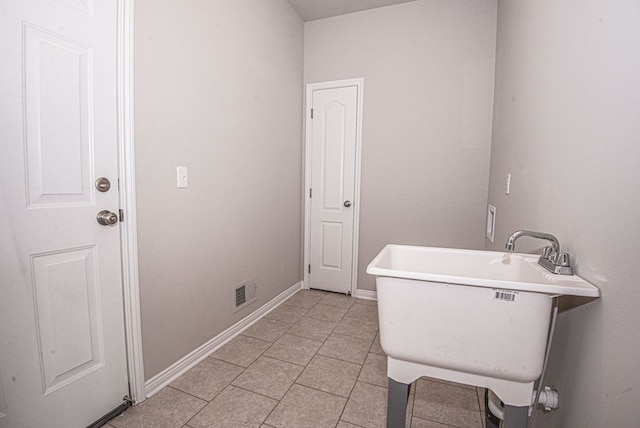 bathroom featuring tile patterned flooring and sink