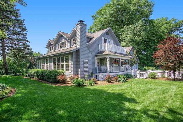 5925 Jagger Rd, Ludington, MI 49431 - view of side of home featuring a balcony, a porch, a chimney, and roof with shingles
