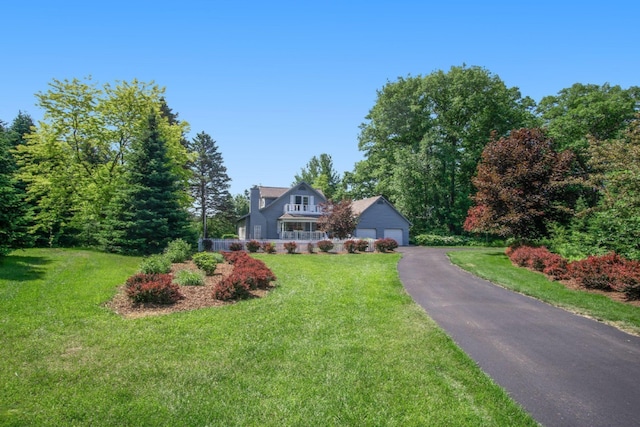 5925 Jagger Rd, Ludington, MI 49431 - cape cod home with a front lawn and asphalt driveway