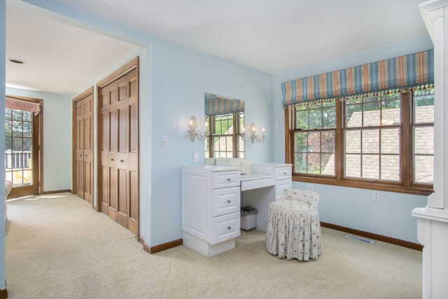 5925 Jagger Rd, Ludington, MI 49431 - bedroom featuring light carpet, multiple closets, and an office area