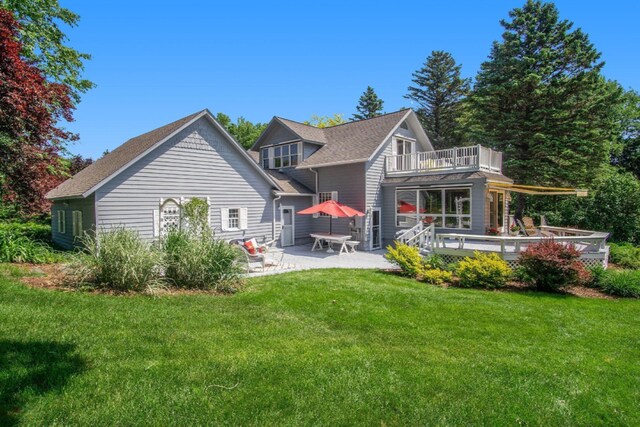 5925 Jagger Rd, Ludington, MI 49431 - back of property with a balcony, a yard, a patio, and a deck