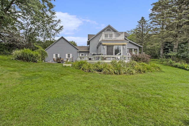 5925 Jagger Rd, Ludington, MI 49431 - rear view of house featuring a balcony, a yard, a wooden deck, and roof with shingles