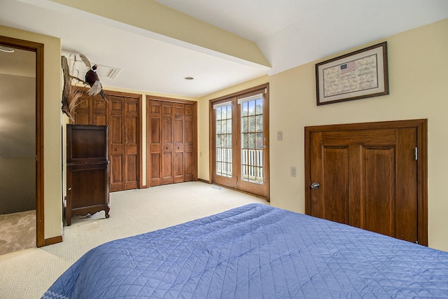 5925 Jagger Rd, Ludington, MI 49431 - bedroom featuring light colored carpet, access to exterior, and multiple closets