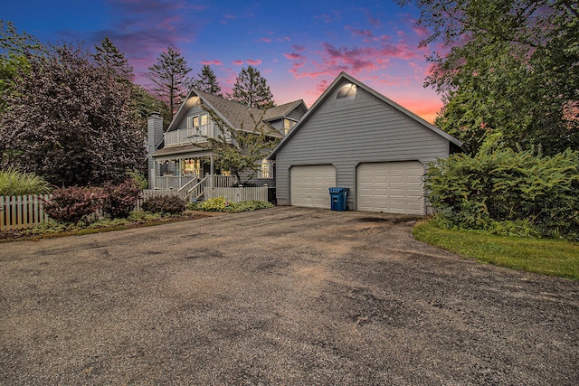 5925 Jagger Rd, Ludington, MI 49431 - view of front of property with a porch, a garage, a chimney, and asphalt driveway