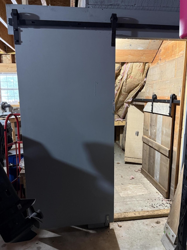 5925 Jagger Rd, Ludington, MI 49431 - detailed view of a barn door and unfinished concrete floors
