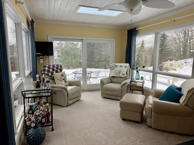 5925 Jagger Rd, Ludington, MI 49431 - carpeted living area with ornamental molding, ceiling fan, and a skylight