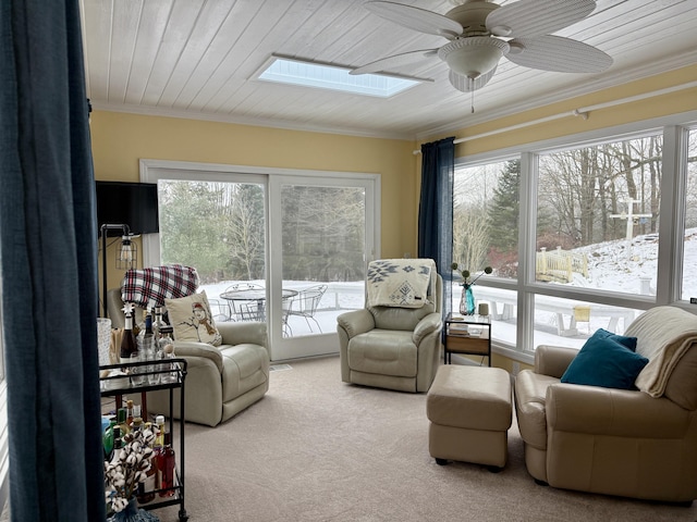 5925 Jagger Rd, Ludington, MI 49431 - carpeted living room featuring a skylight, ceiling fan, and crown molding