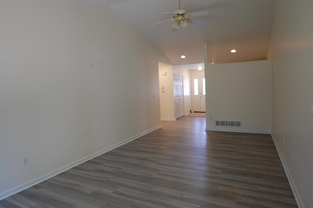 spare room with vaulted ceiling, ceiling fan, and dark wood-type flooring