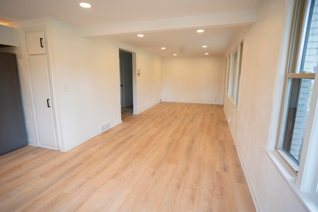 unfurnished room with light wood-type flooring