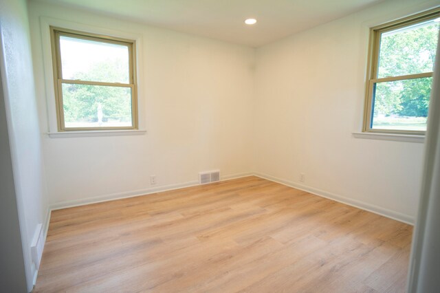 unfurnished room with light hardwood / wood-style floors