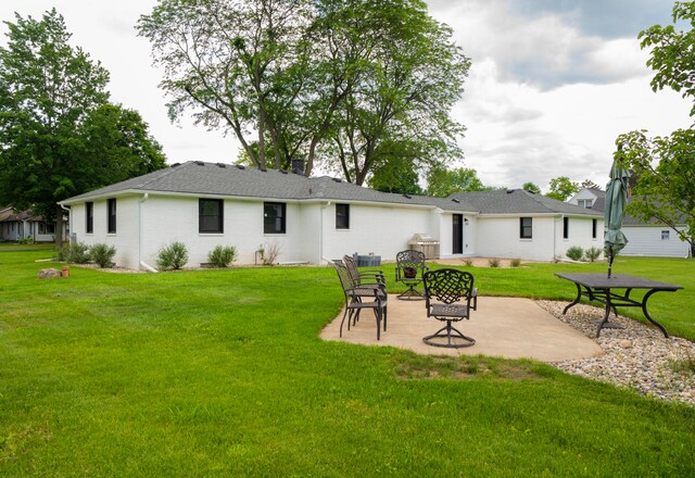 back of house featuring a yard and a patio area