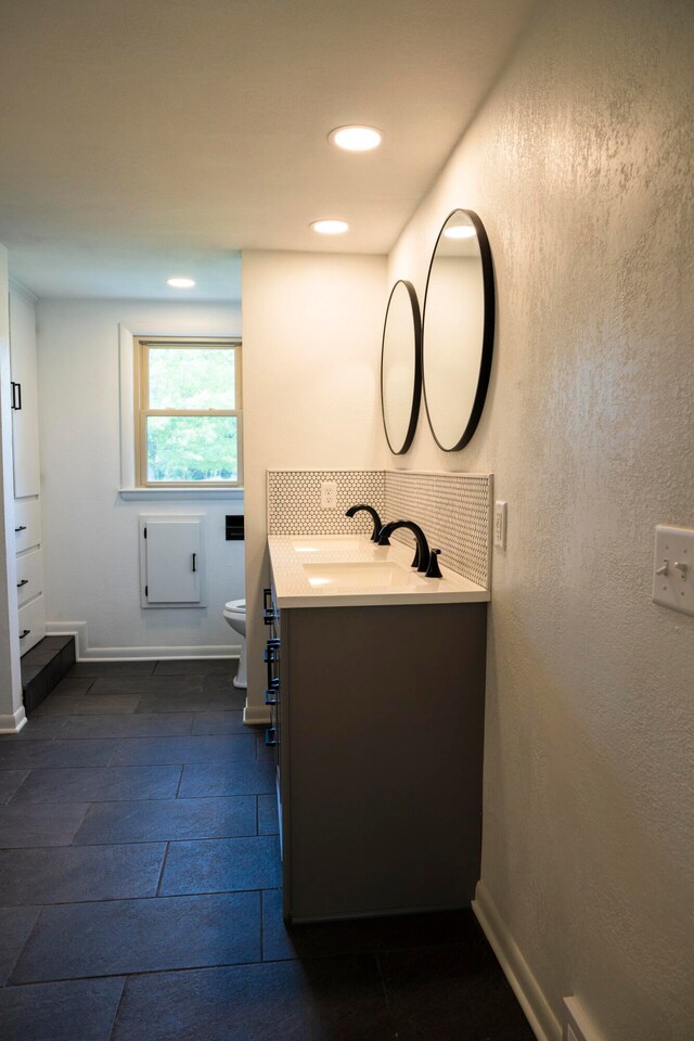 bathroom featuring vanity and toilet