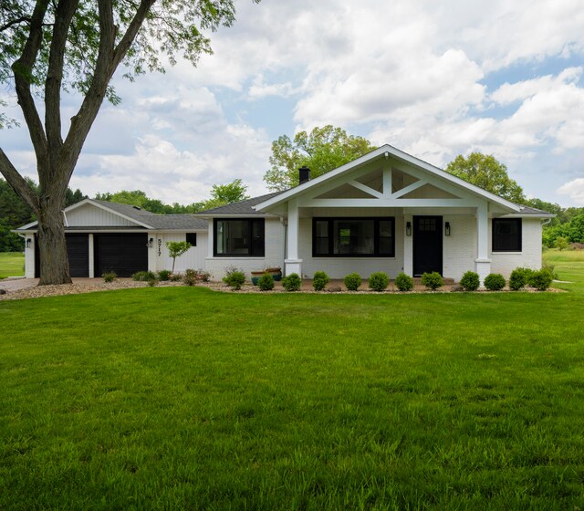 view of front of house featuring a garage and a front lawn