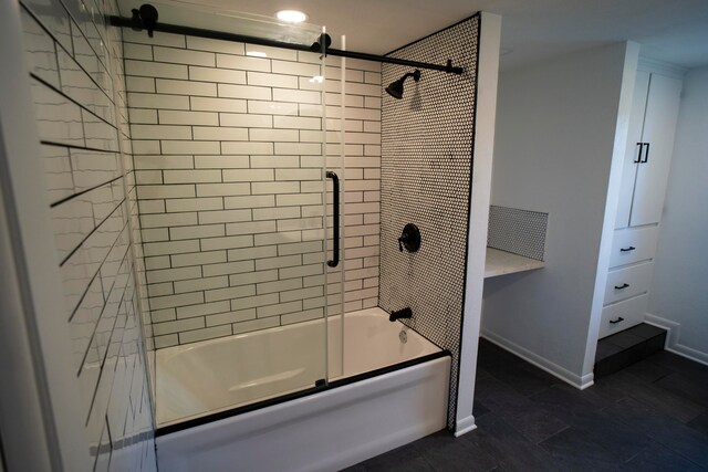 bathroom featuring tile patterned flooring and combined bath / shower with glass door