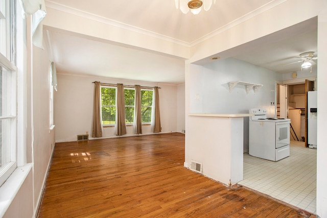 interior space with ceiling fan, wood-type flooring, and crown molding