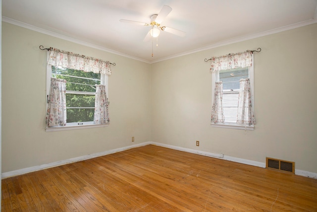 empty room featuring hardwood / wood-style flooring, ceiling fan, and crown molding