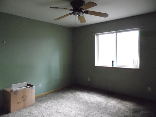 spare room featuring carpet flooring and ceiling fan