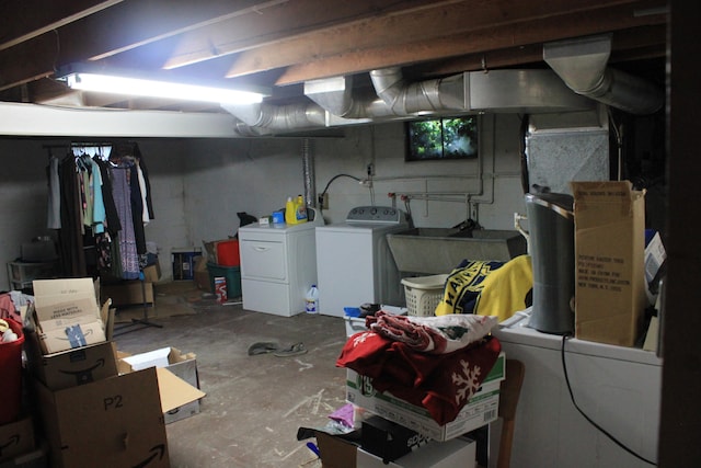 basement with washing machine and dryer and sink