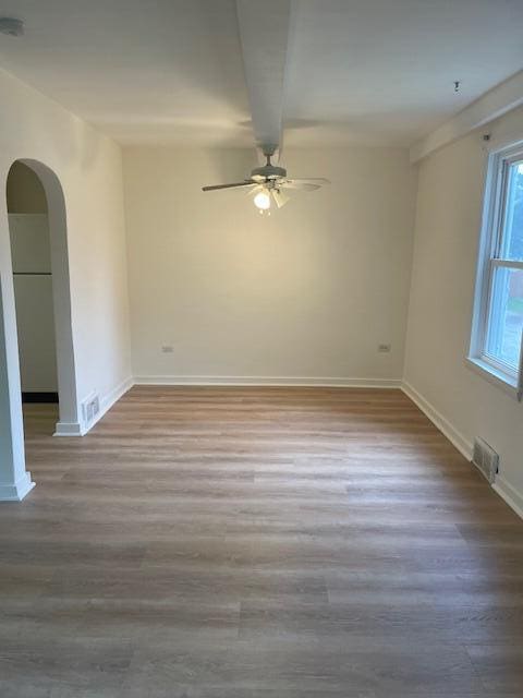 empty room with ceiling fan and wood-type flooring