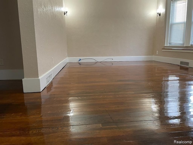 spare room with dark hardwood / wood-style floors