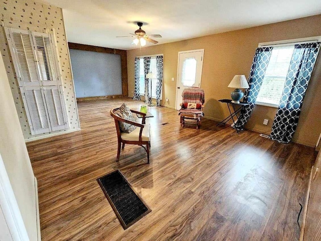 interior space featuring wood-type flooring, a wealth of natural light, and ceiling fan