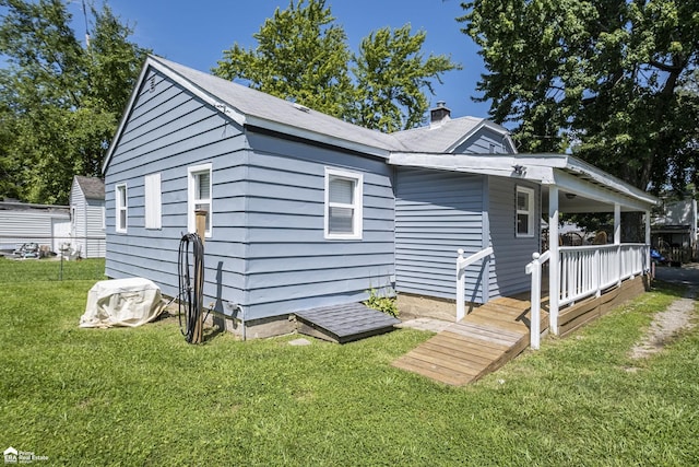 1029 Boatfield Ave, Flint, MI 48507 - view of front of house featuring a front yard, a porch, and a chimney