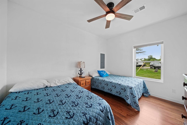 bedroom featuring electric panel, ceiling fan, and dark wood-type flooring