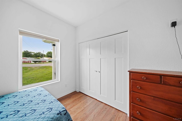 bedroom featuring light wood-type flooring and a closet