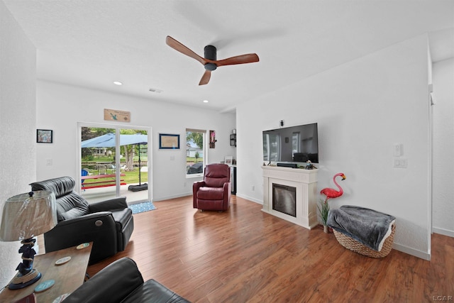 living room featuring hardwood / wood-style floors and ceiling fan