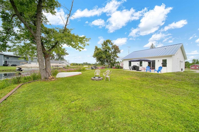 view of yard featuring a fire pit and a patio area