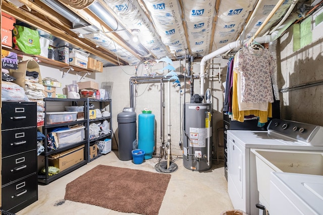 basement featuring water heater and washer and clothes dryer