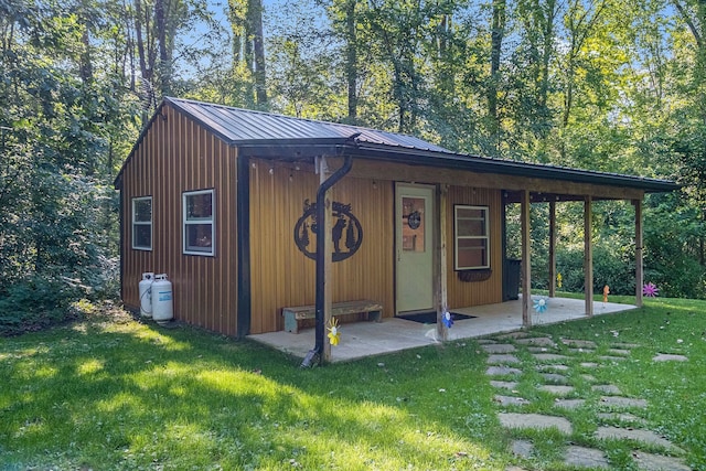 view of outbuilding with a yard