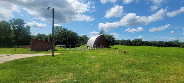 3150 Swaffer Rd, Millington, MI 48746 - view of yard featuring a barn, an outbuilding, and a view of countryside