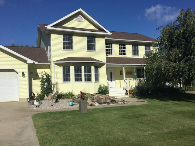 view of front facade with a porch, a garage, and a front yard